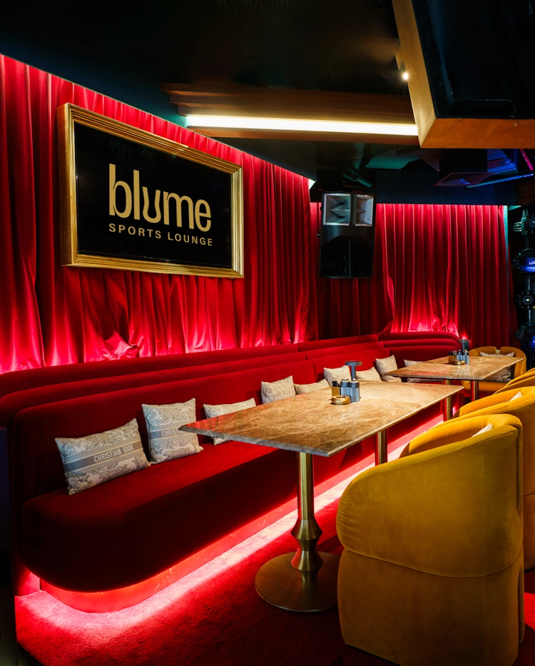 About Blume Sports Lounge Red lounge seating and screens at Blume Sports Lounge Dubai Marina